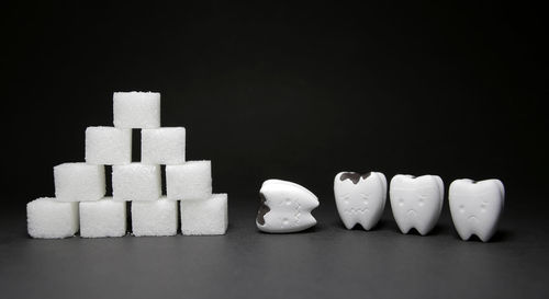 Close-up of bread on table against black background