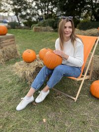 Portrait of young woman sitting on grassy field