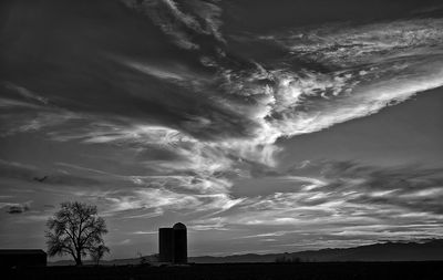 Scenic view of silhouette buildings against sky at sunset