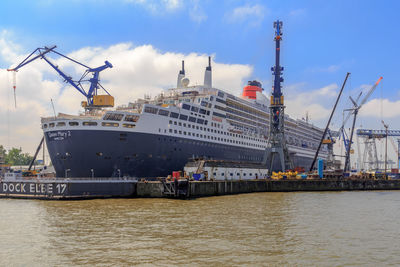 Ship at harbor against sky