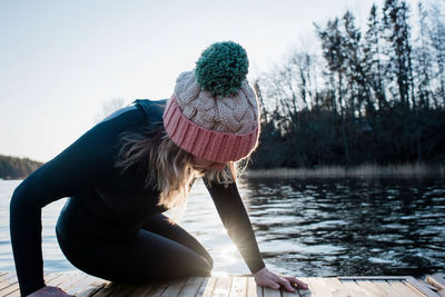 Woman climbing out of the water from cold water ice swimming in sweden