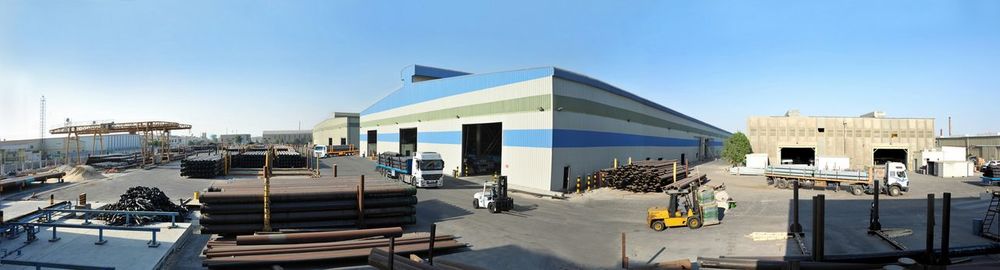 Panoramic view of modern buildings against clear blue sky