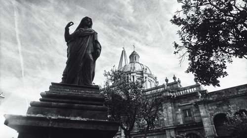 Low angle view of statue against cloudy sky