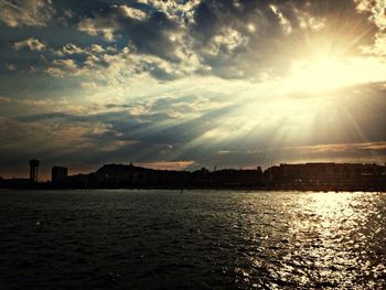 Scenic view of river against sky at sunset