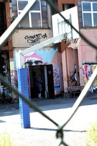 Woman standing in front of graffiti on wall