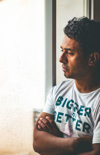 Portrait of young man looking away at home