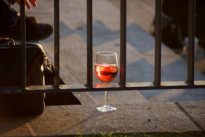Red wine glass on table by window