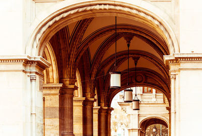 Low angle view of hanging lights at arched structure