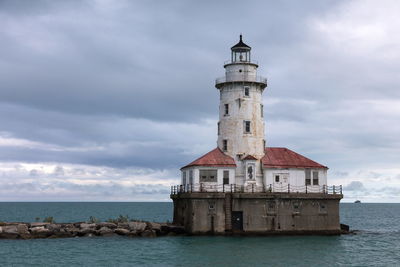 Red and white decommissioned offshore lighthouse, lake michigan