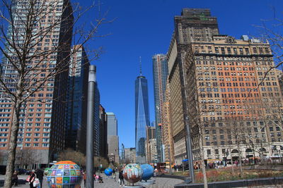 Buildings in city against blue sky