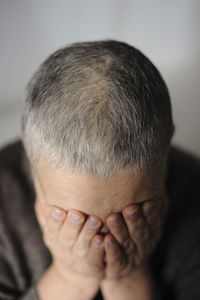 Mature woman covering her face