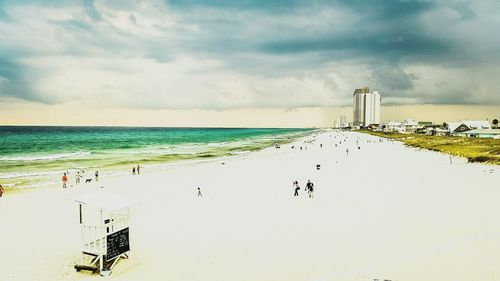 Scenic view of beach against cloudy sky