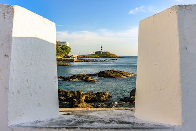 Barra lighthouse seen through the walls of the fortress of santa maria in  salvador, bahia