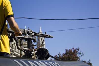 Low angle view of man riding motorcycle against clear sky