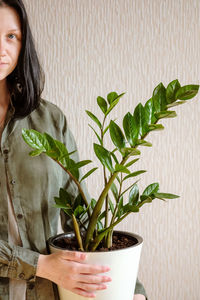 Portrait of woman with potted plants