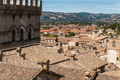 High angle view of castle and houses against sky