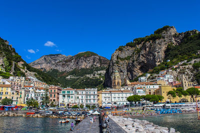Panoramic view of the city of amalfi from the jetty with the sea, the beach, the church and  houses