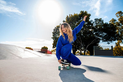 Smiling woman skating at park