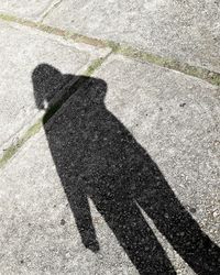 Shadow of person on street in city