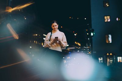 Woman standing at night