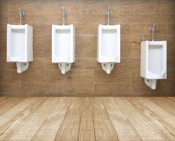 Close-up of urinals at public restroom