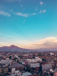 High angle shot of townscape against sky at sunset