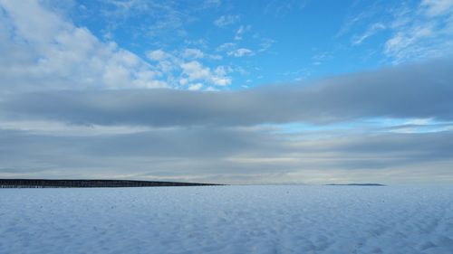 Scenic view of frozen landscape against sky