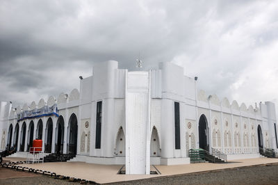 Low angle view of building against cloudy sky