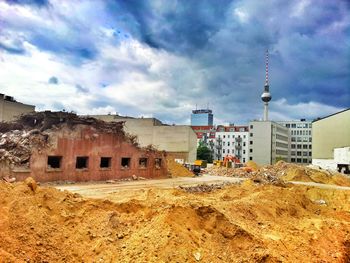 Buildings against cloudy sky