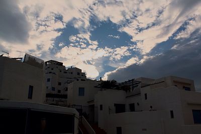 Low angle view of building against cloudy sky