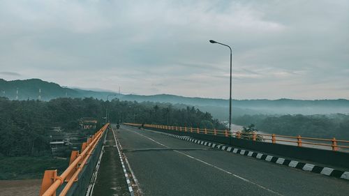 Road by street against sky