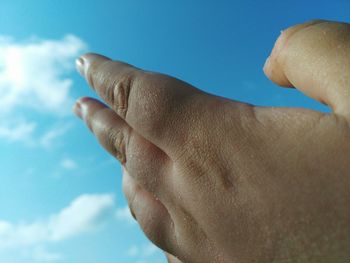 Cropped image of hand against sky