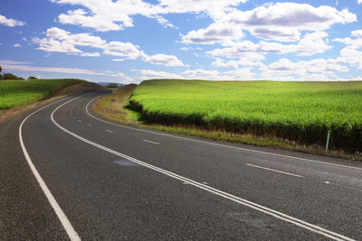 Road passing through landscape against sky