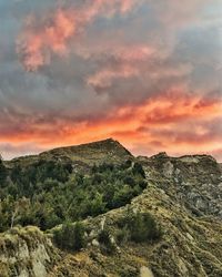 Scenic view of mountains against sky at sunset