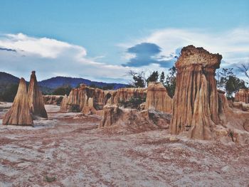 Rock formations on landscape against sky