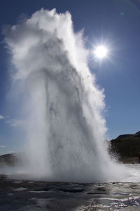 Scenic view of waterfall against sky