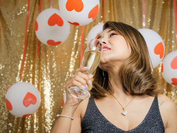 Portrait of woman holding balloons