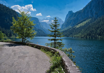 Scenic view of lake by mountains against sky