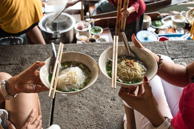 Midsection of woman holding food on table