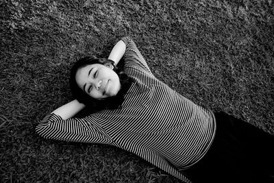 High angle portrait of woman lying on rug