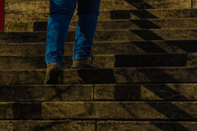 Low section of man moving up on steps