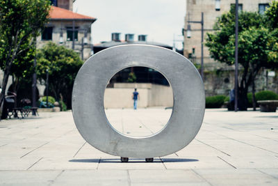 Rear view of man and building through letter o