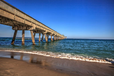 Deerfield beach pier under a blue sky in deerfield, florida