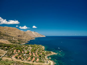 High angle view of sea against blue sky