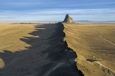 Aerial with leading line of lava towards shiprock in new mexico