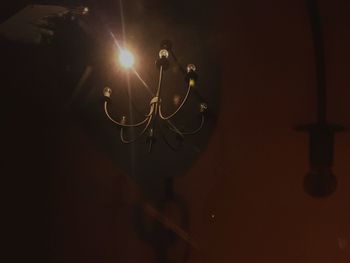 Close-up of illuminated lighting equipment on wall