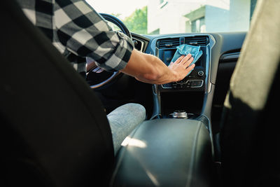 Midsection of man driving car
