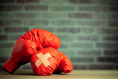 Close-up of red toy on table against wall
