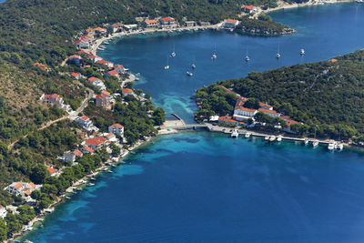 High angle view of swimming pool by sea against buildings