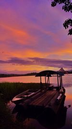 Boats in lake at sunset